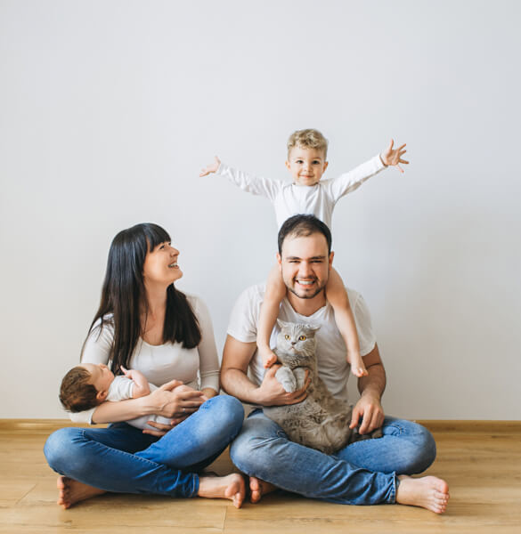 Family sat on hardwood floor | Affordable Floors